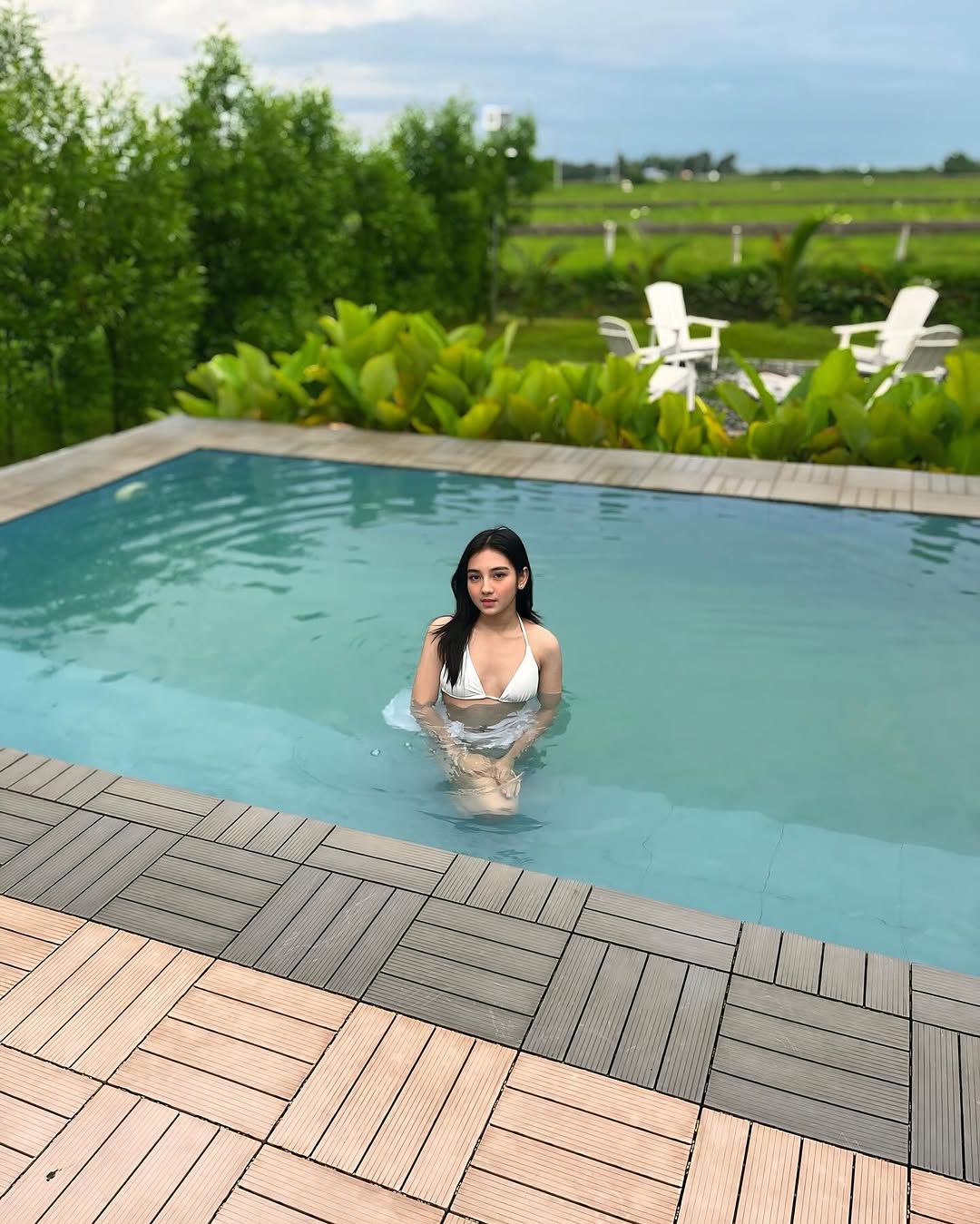 Pool at Kalinaya with garden chairs and open sky