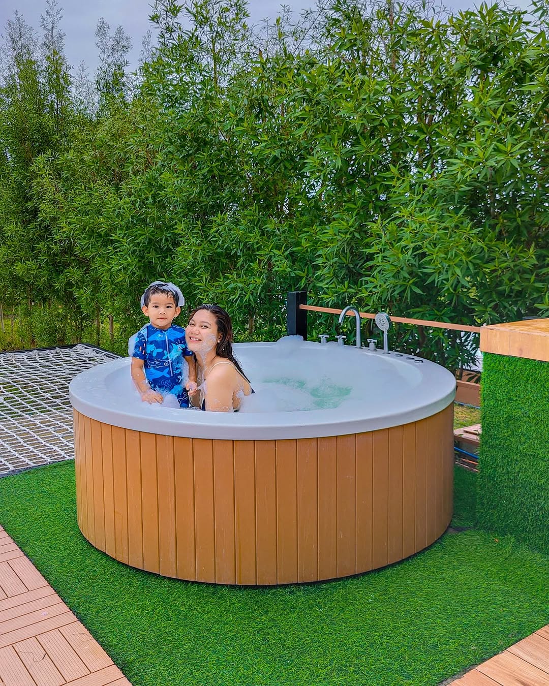 The Garden Dome wood barrel heated jacuzzi with mother and child